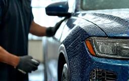 Car exterior being washed by a technician